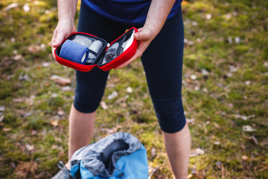 Woman opening first aid kit outdoors